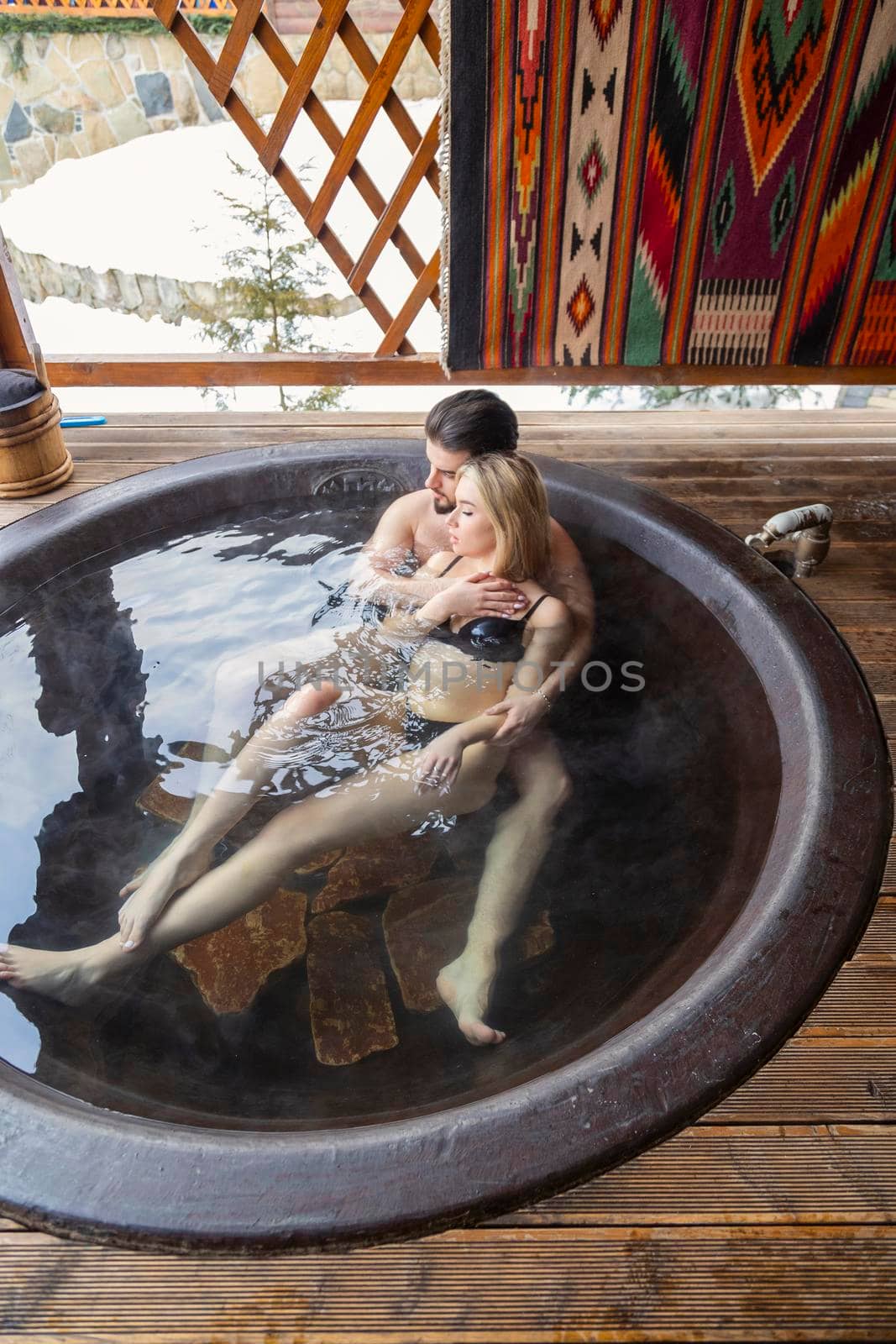 young couple bathing in a vat by zokov