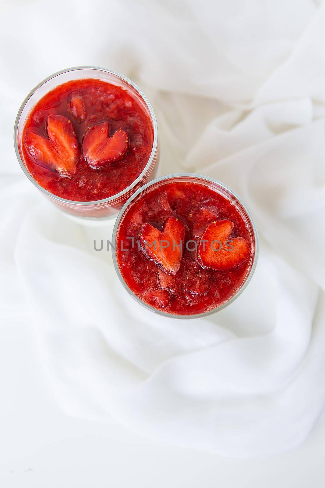 Strawberry and chia seed pudding in a cup for breakfast and strawberries in the shape of a heart. February 14, St. Valentine's Day. by sfinks