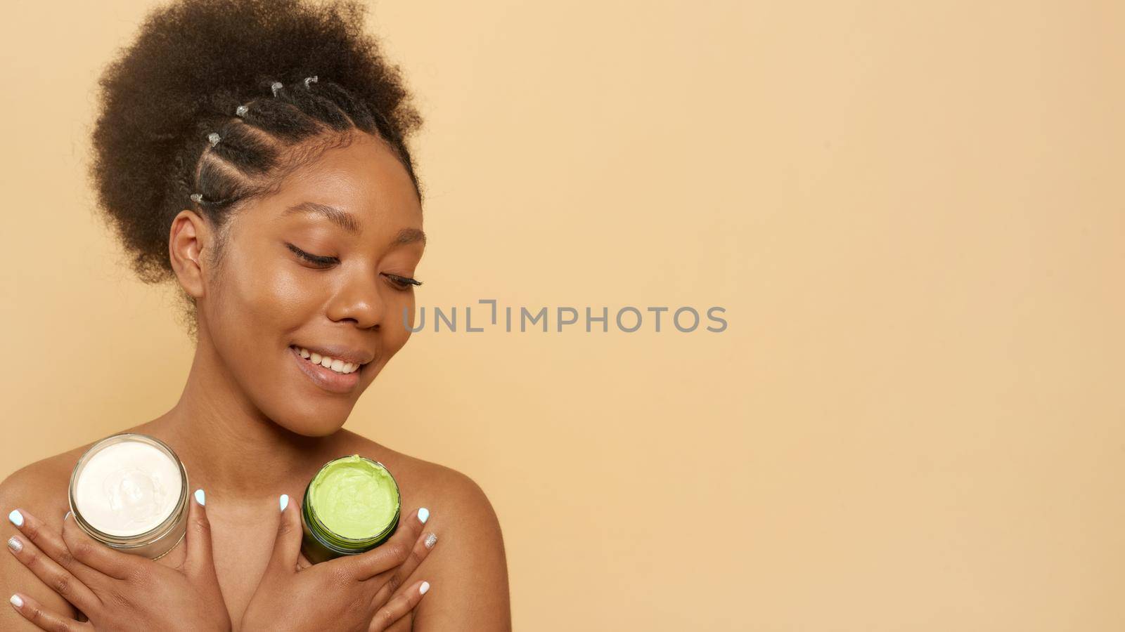 Skin Care Concept. Smiling african american woman holding jar with moisturizing cream in studio. Web banner.