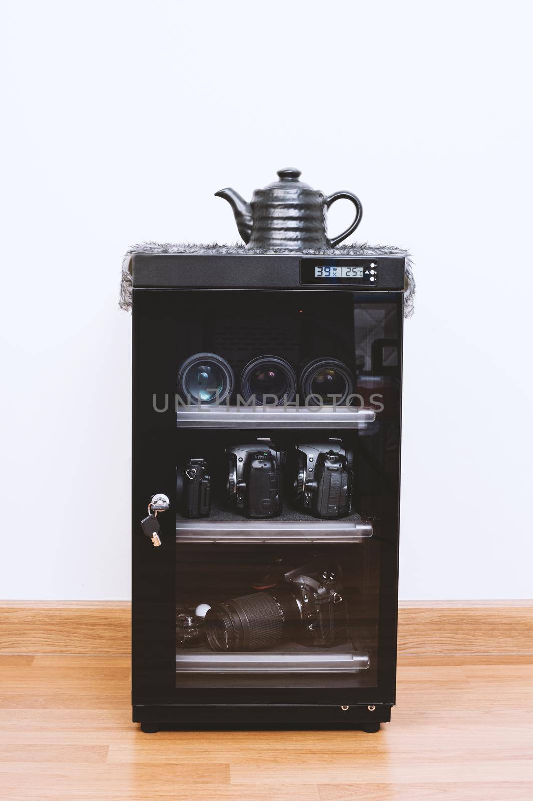 electronic dehumidify dry cabinet for storage cameras lens and other photography equipment. Closeup at status display of the cabinet.