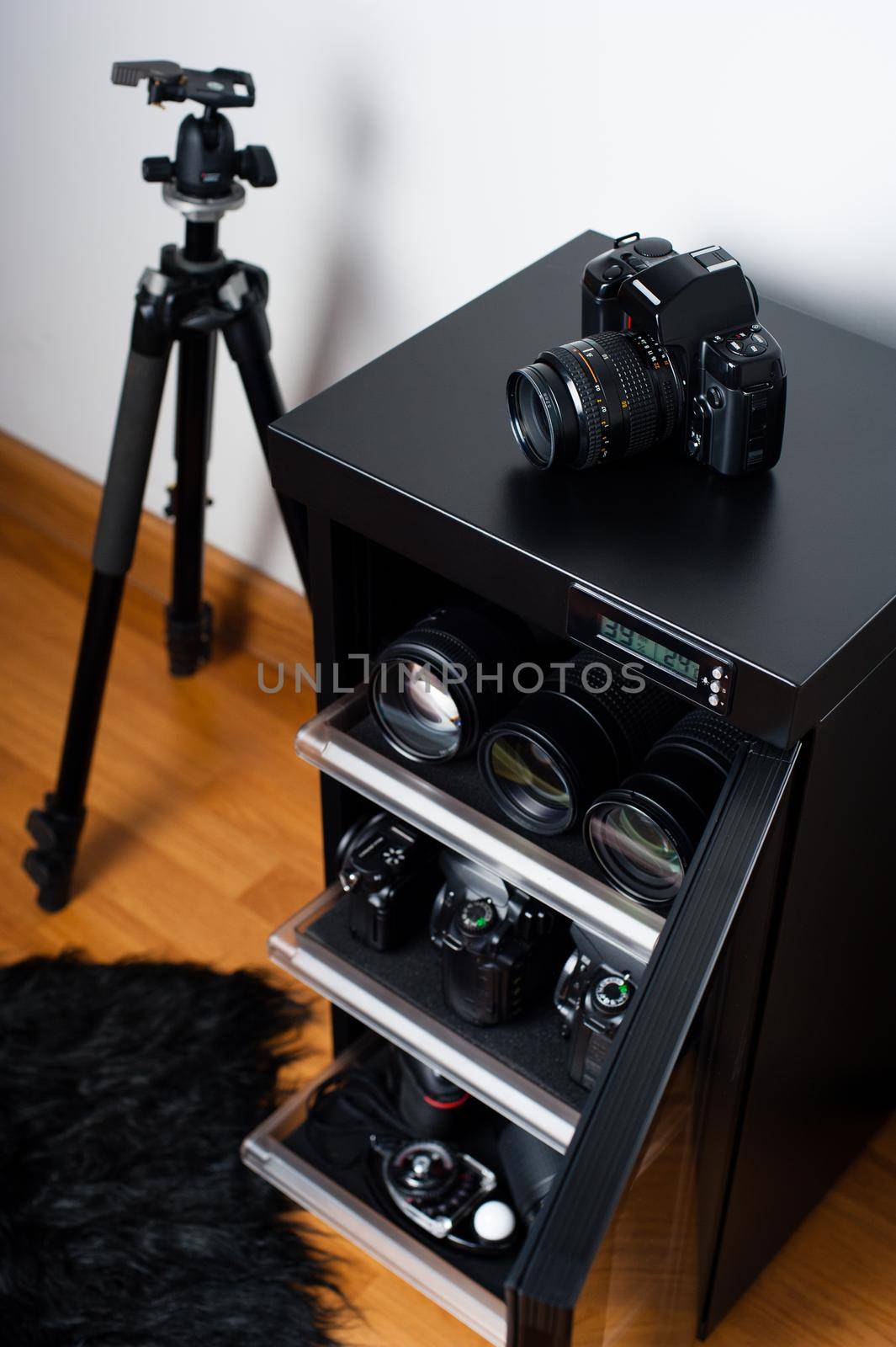 electronic dehumidify dry cabinet for storage cameras lens and other photography equipment. Shallow depth of field, closeup at camera on the cabinet.