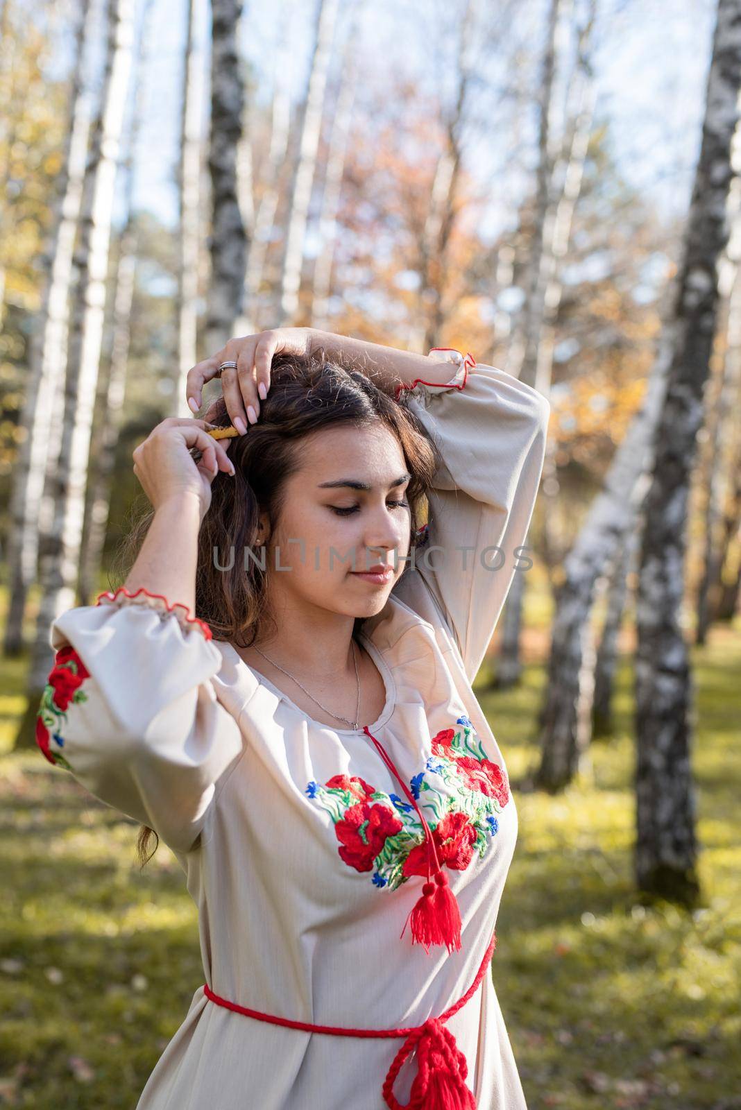 Indigenous people. beautiful woman in national ukrainian national traditional costume clothes walking in forest