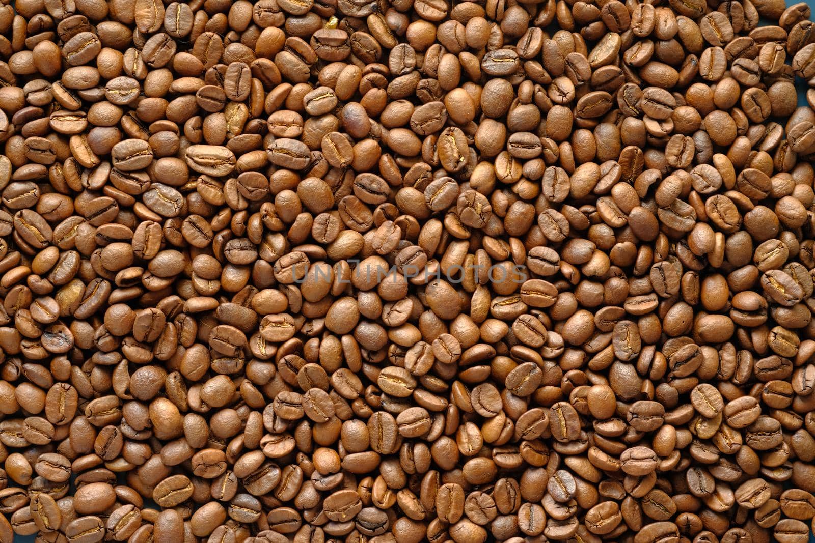 top view of fresh coffee beans on black background .