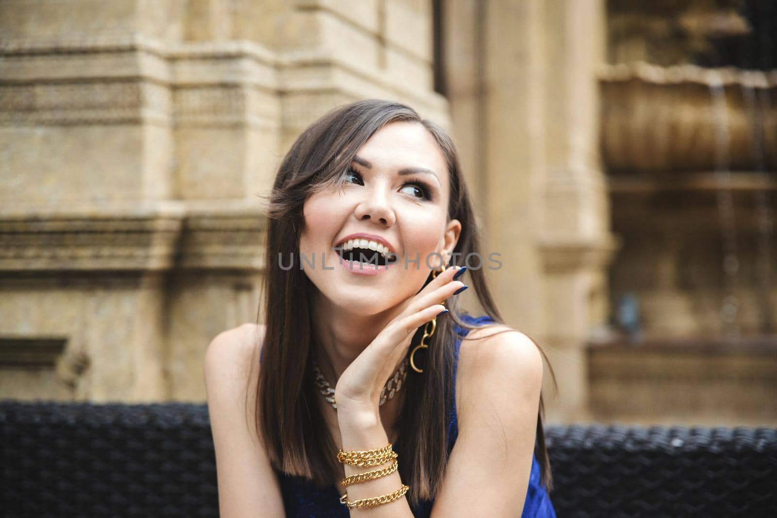 Young woman with surprised emotion on her face on a summer terrace in a restaurant.