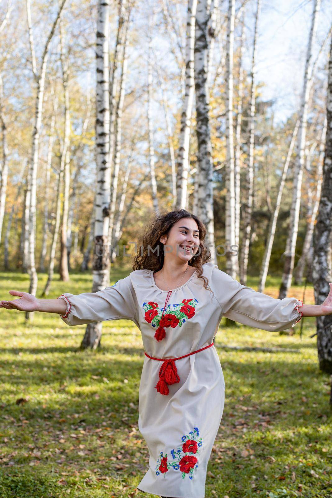 beautiful woman in ukrainian national traditional costume clothes dancing in forest by Desperada