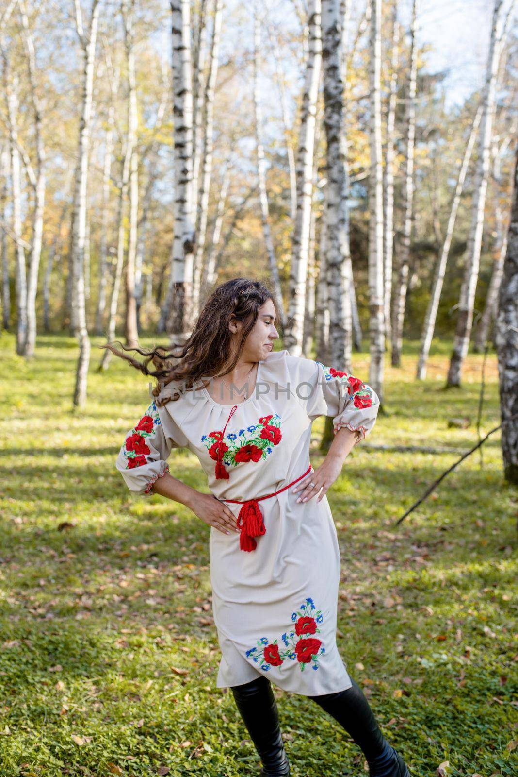 Indigenous people. beautiful woman in national ukrainian national traditional costume clothes dancing in forest