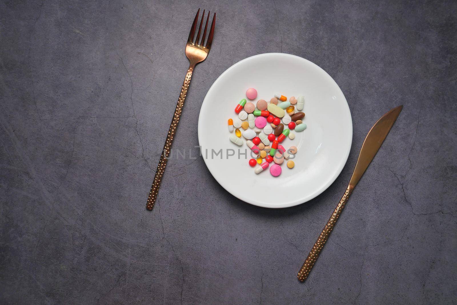 close up of colorful pills on plate .