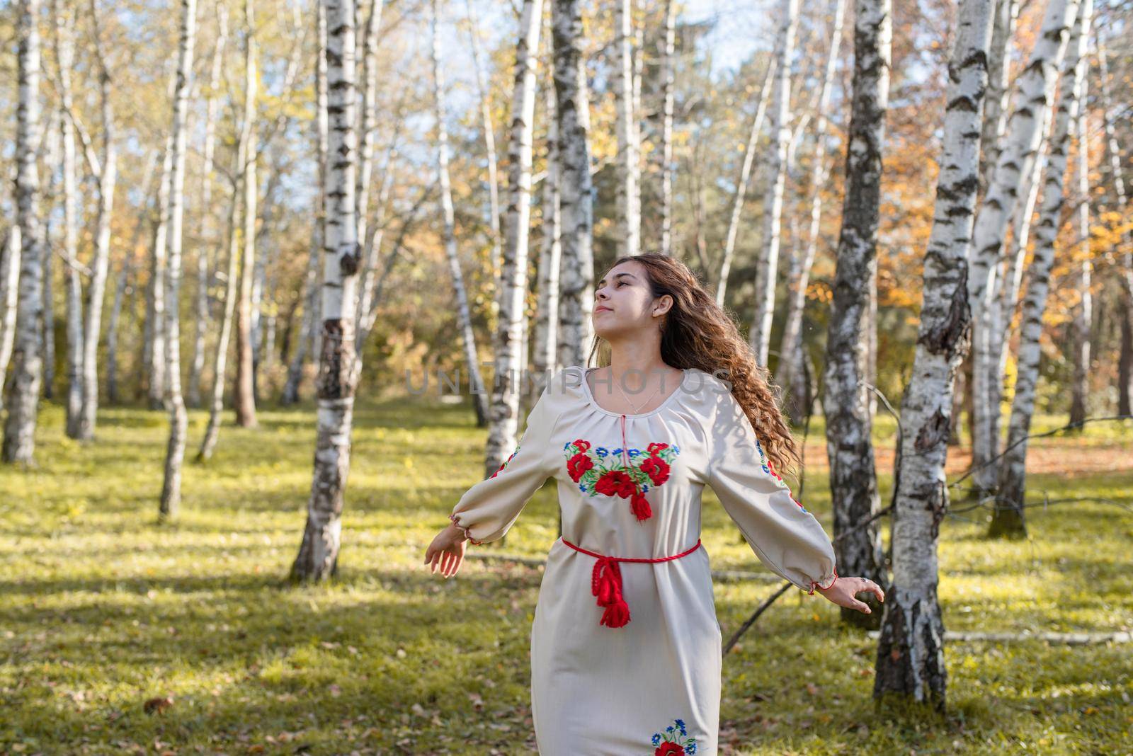 Indigenous people. beautiful woman in national ukrainian national traditional costume clothes dancing in forest