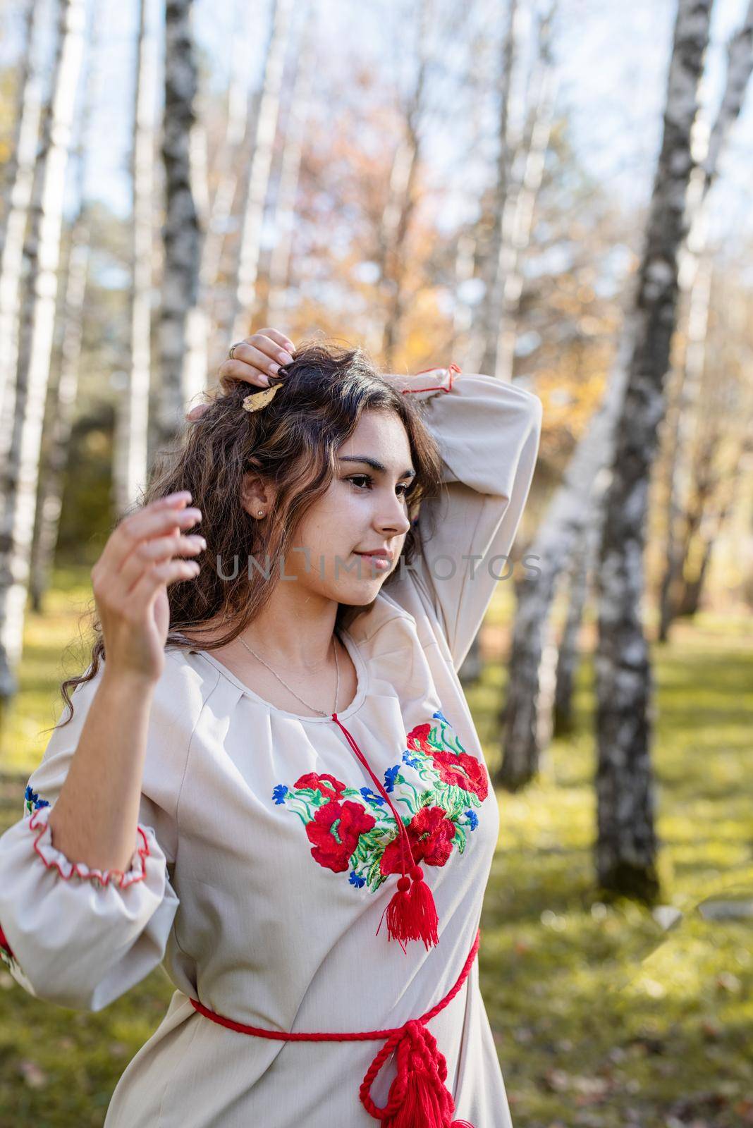 Indigenous people. beautiful woman in national ukrainian national traditional costume clothes walking in forest