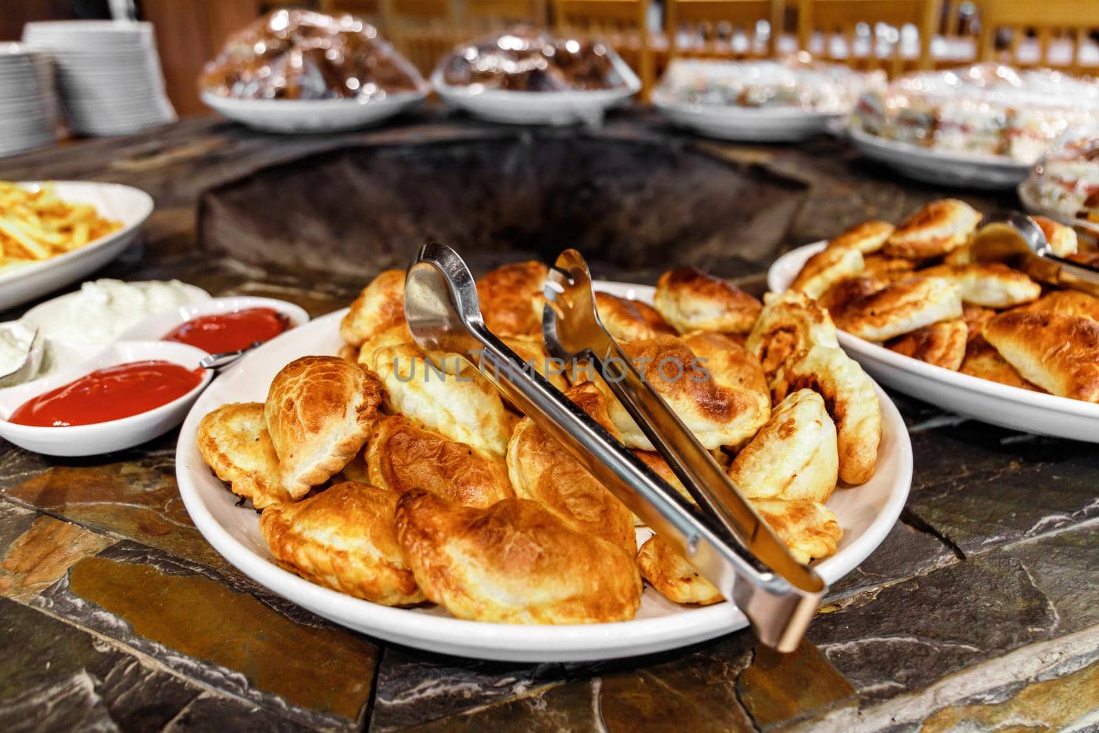 Samsa, sandwiches and other snacks and bakery are on the buffet area of the event day.