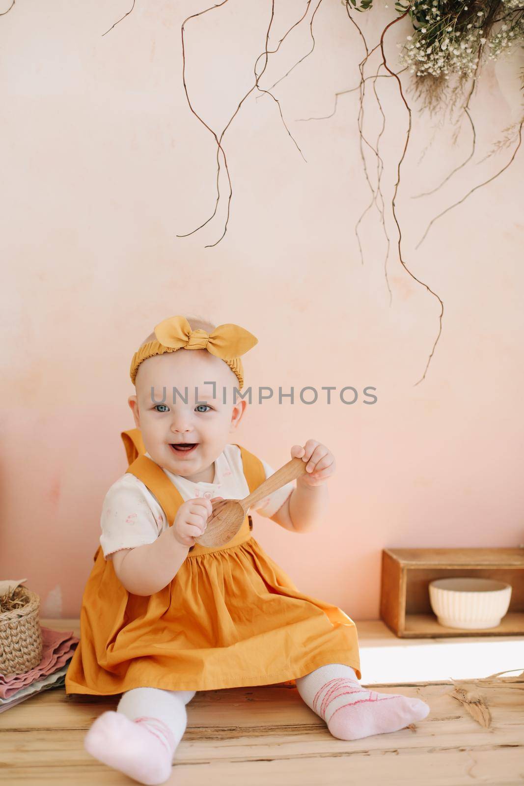 Adorable happy baby girl playing in a sunny room. Portrait of a happy child at home.