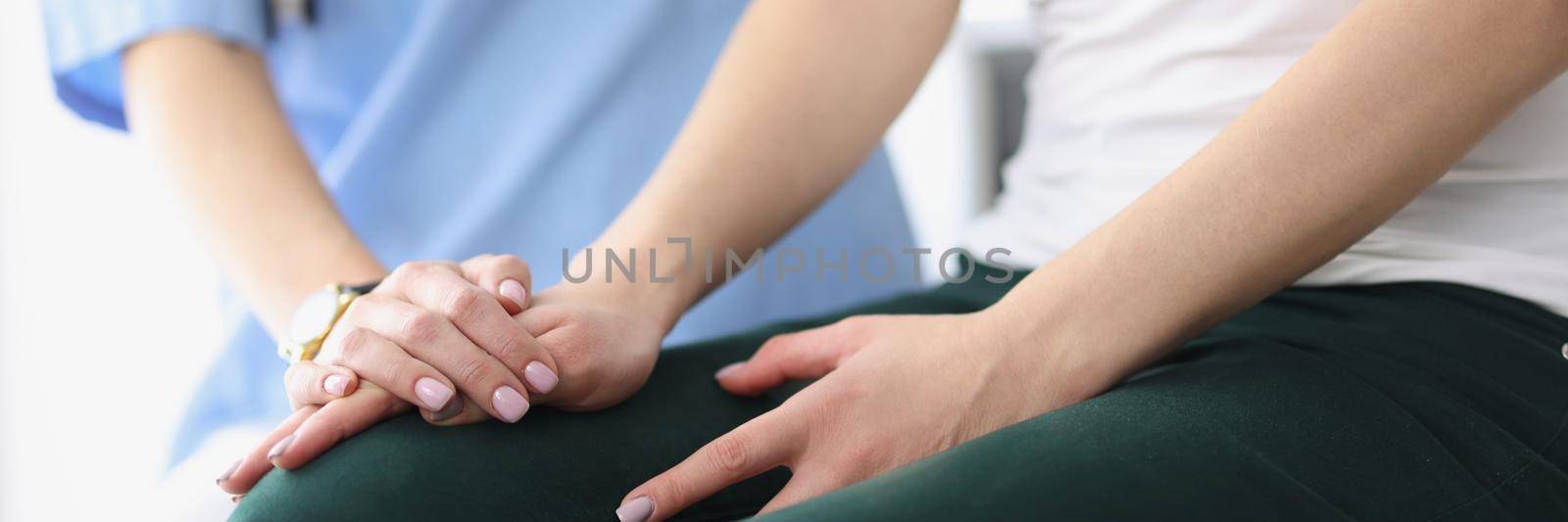 Close-up of women sitting together. Practitioner supporting sick patient after bad news. Doctor giving encouragement to woman and holding hands. Keep calm and compassion concept