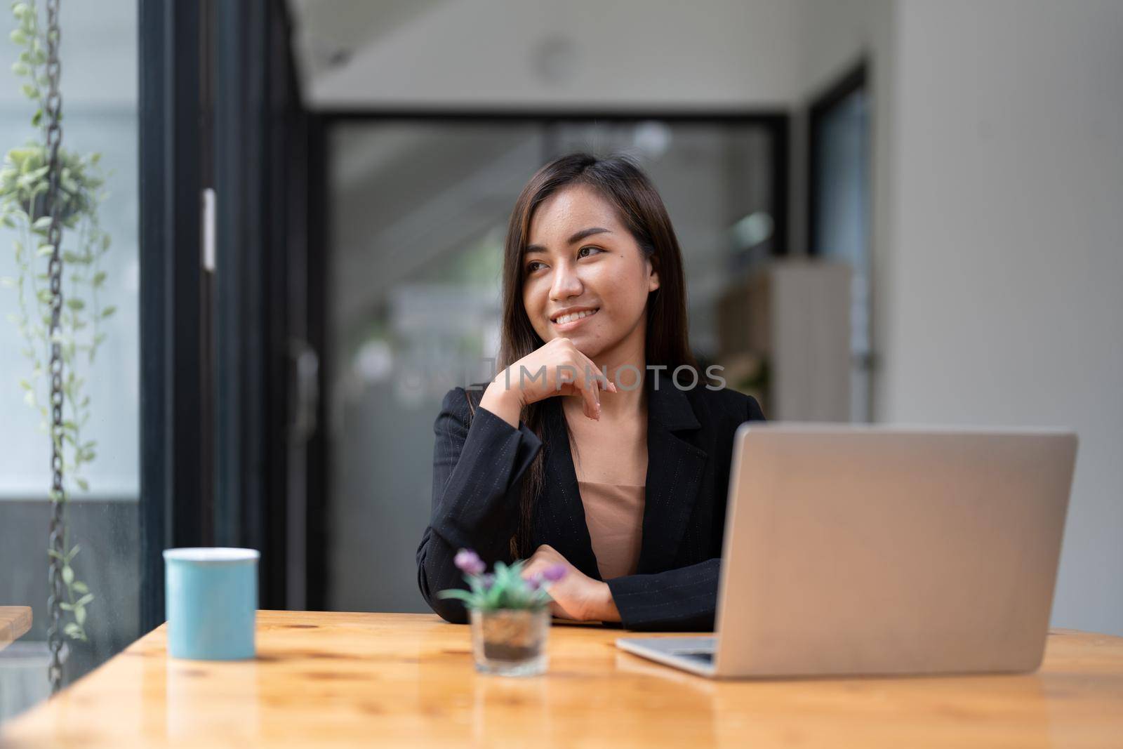 Portrait of young asian woman freelance online working from home with laptop computer