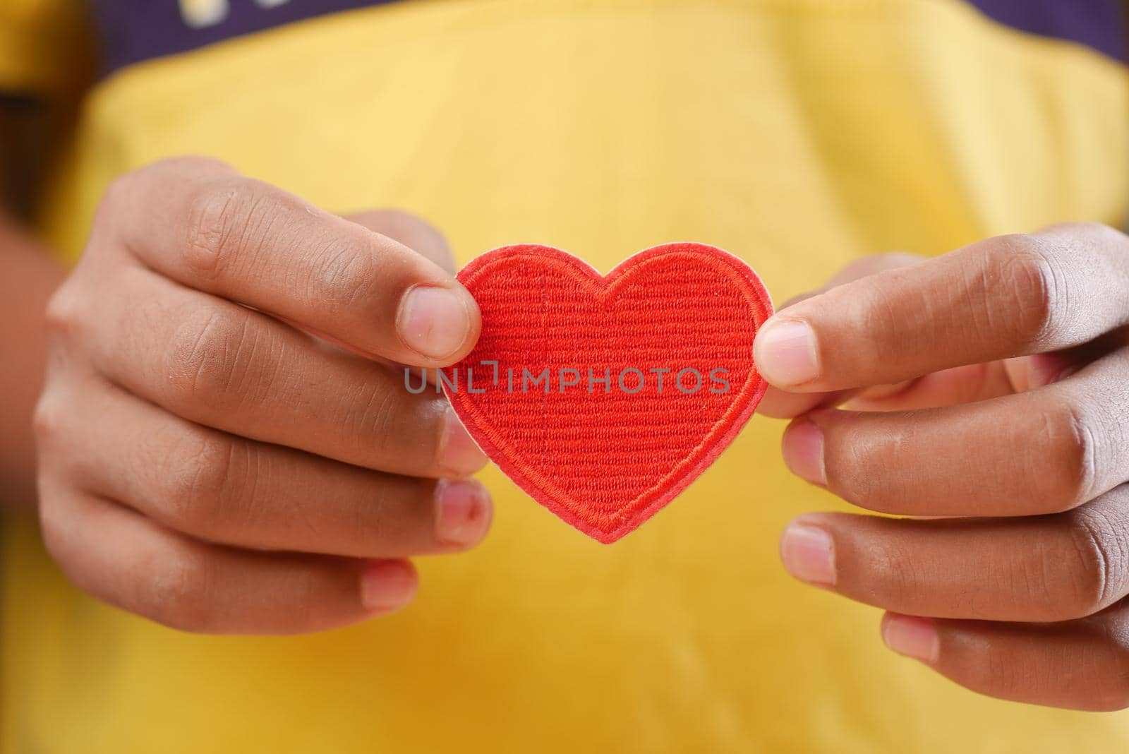 men holding red heart close up .