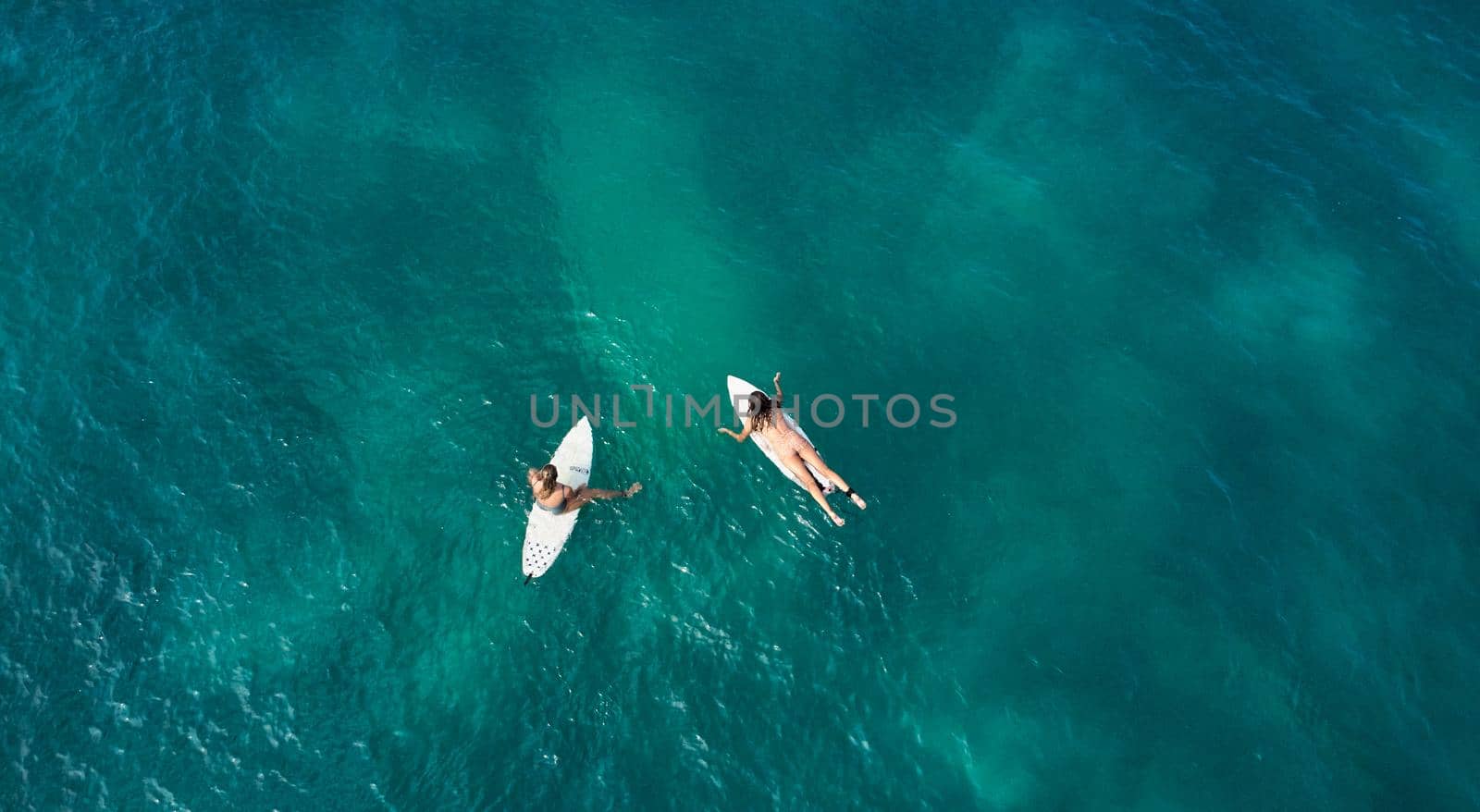 Aerial view of the ocean and surfer girls. Surfing in Midigama. Sri Lanka