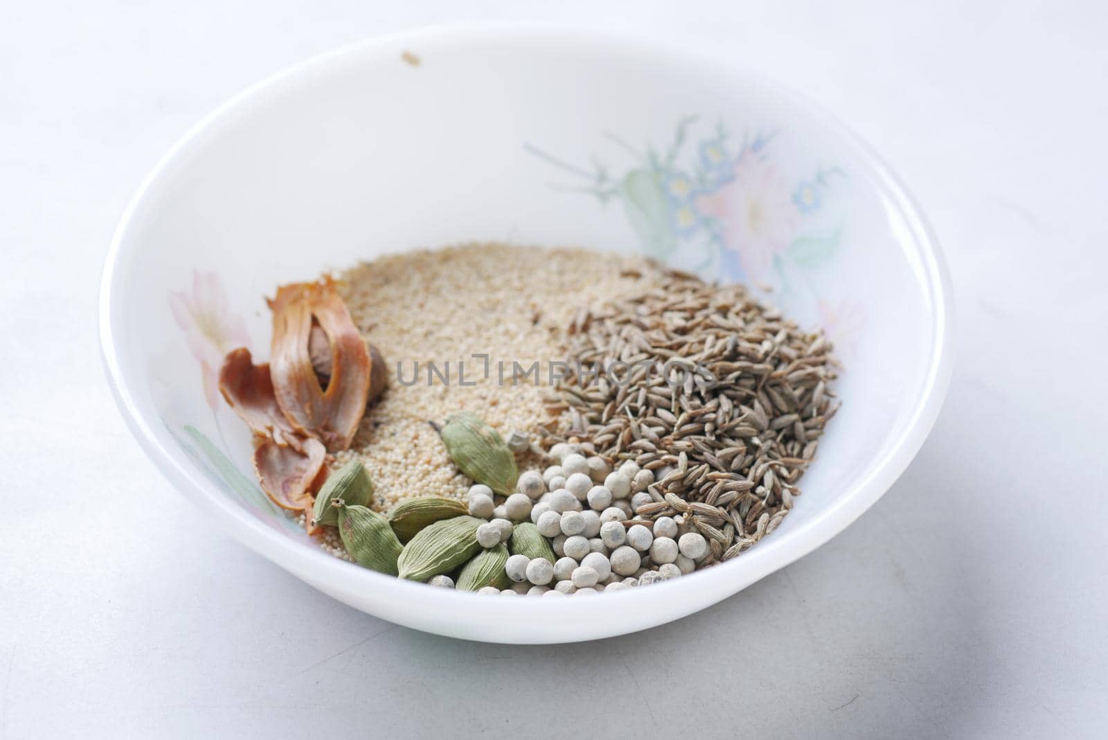 mixed of different spice on a bowl on table .