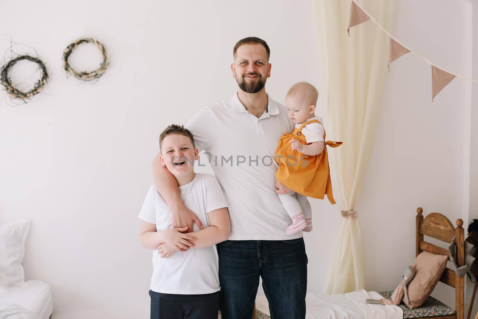 Father with his son and daughter at home. Happy family having fun together. Happy Father's Day by paralisart