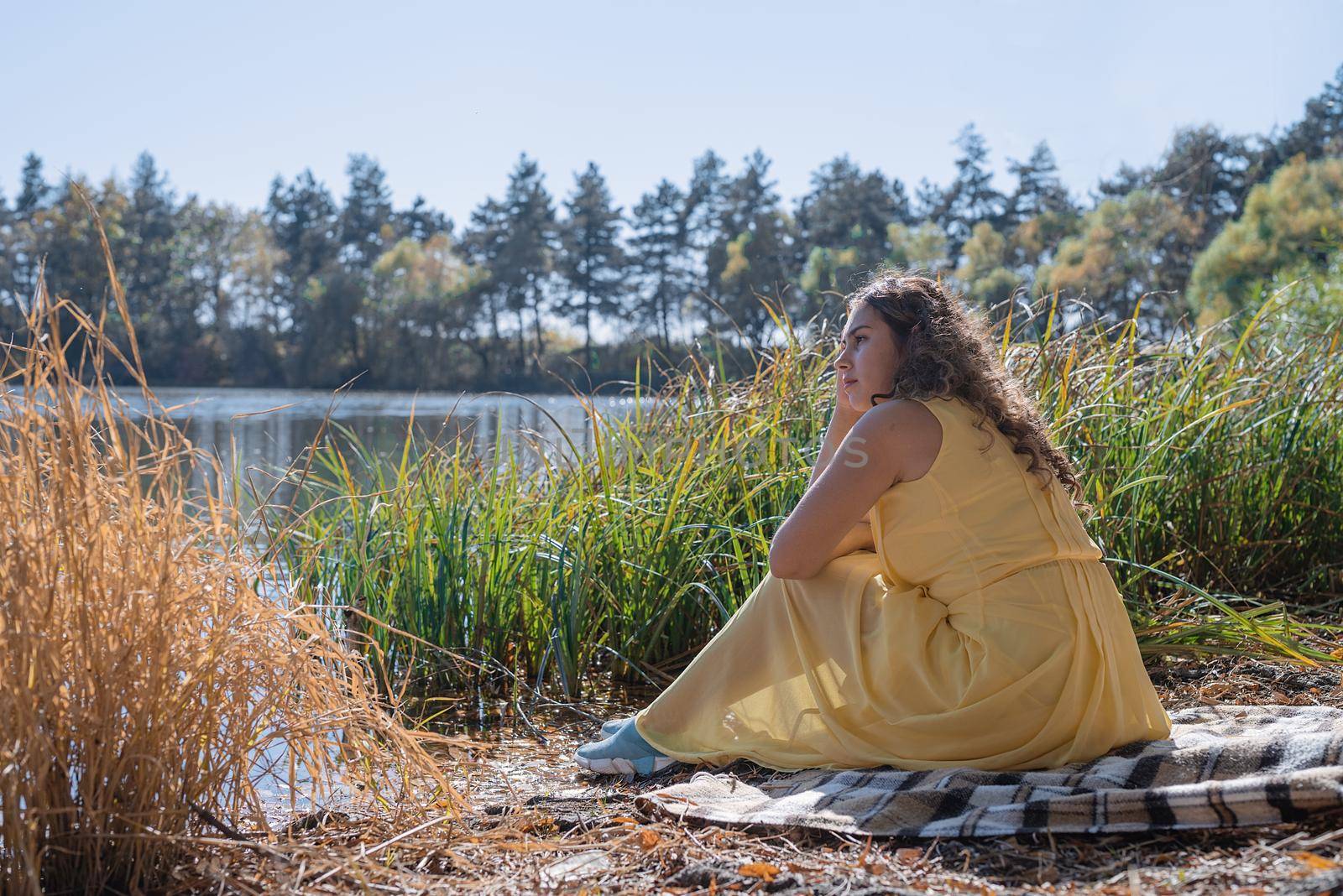 Beautiful woman in yellow dress on a picnic by Desperada