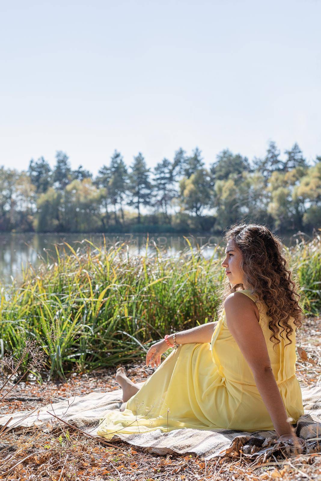 Beautiful woman in yellow dress on a picnic by Desperada