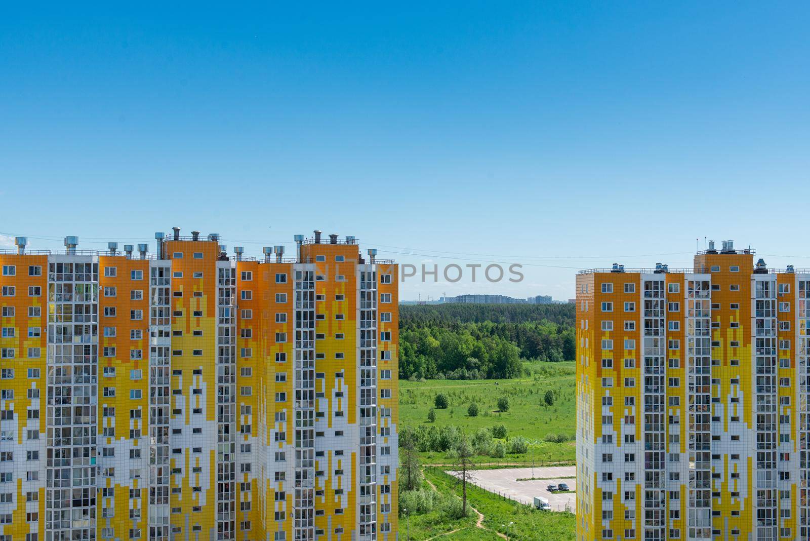 view of the city through between two apartment buildings by marynkin