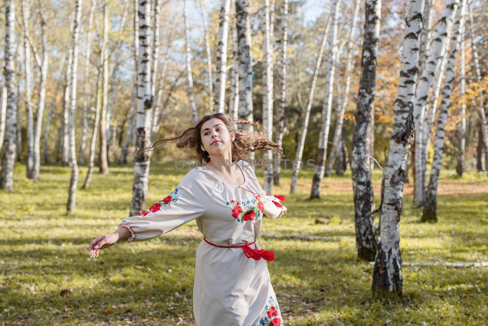 beautiful woman in ukrainian national traditional costume clothes dancing in forest by Desperada