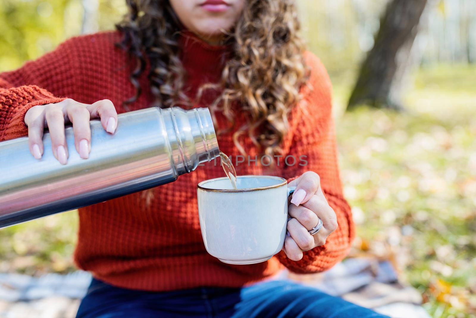 Beautiful woman in red sweater on a picnic in a autumn forest by Desperada