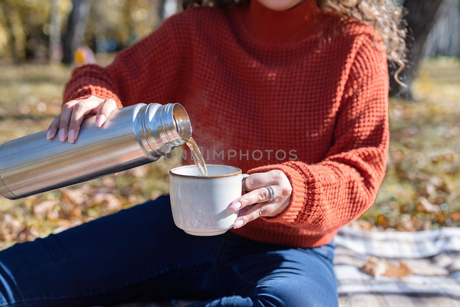 Beautiful woman in red sweater on a picnic in a autumn forest by Desperada