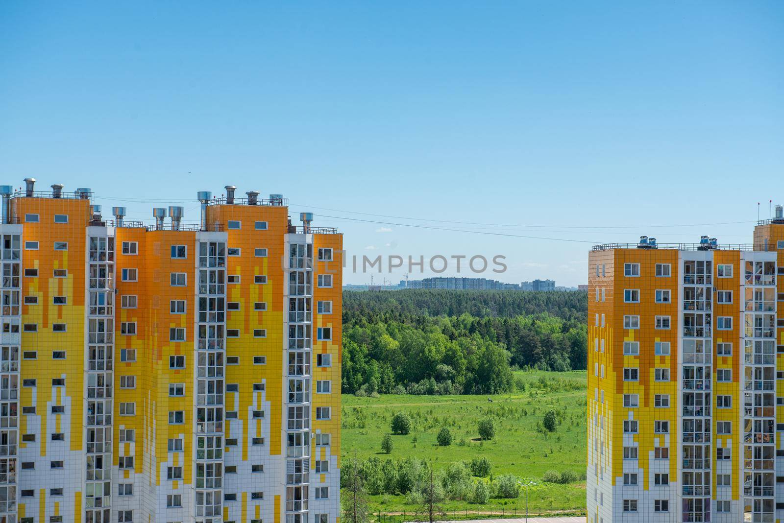 view of the city through between two apartment buildings by marynkin