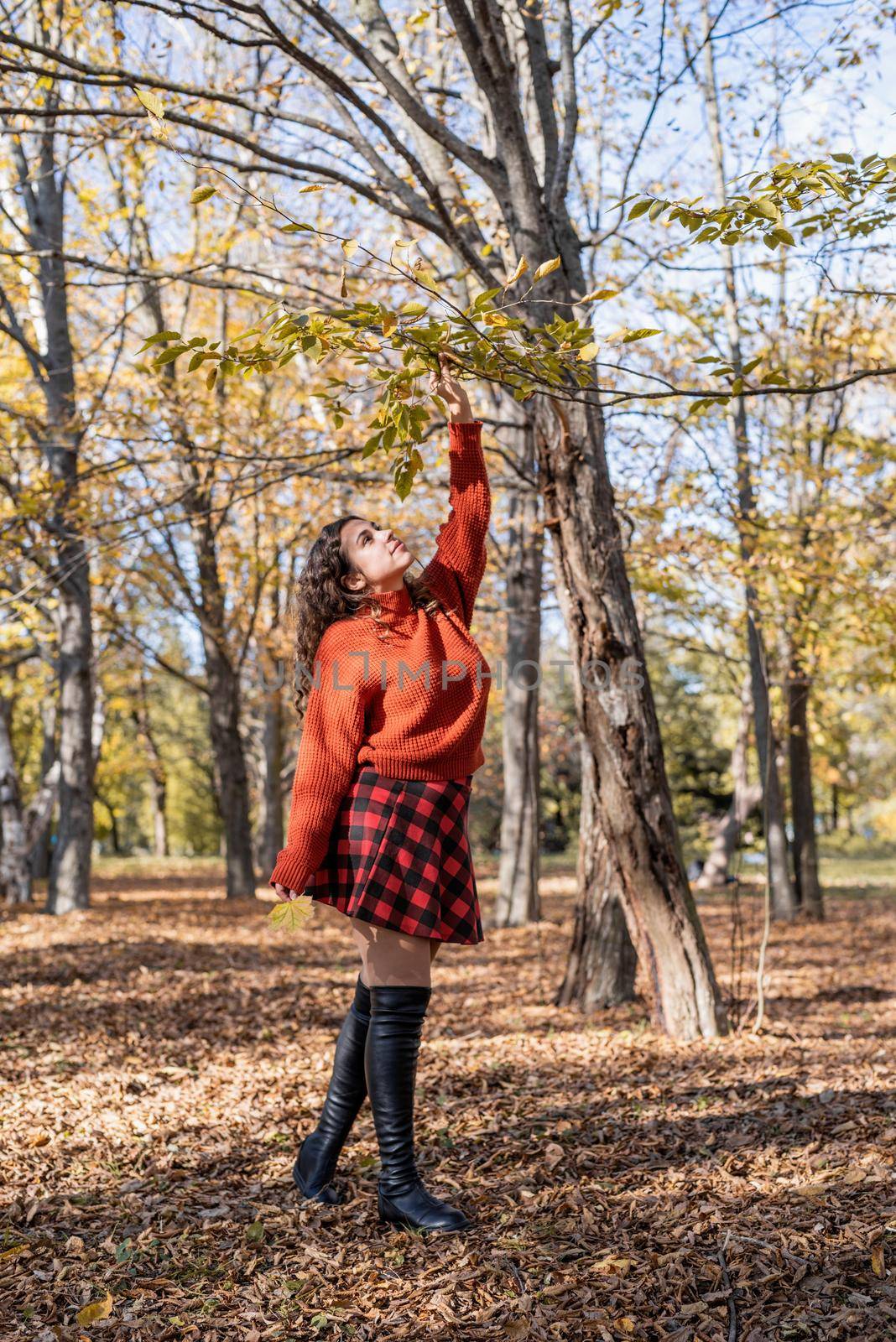 young happy woman walking in autumn forest by Desperada