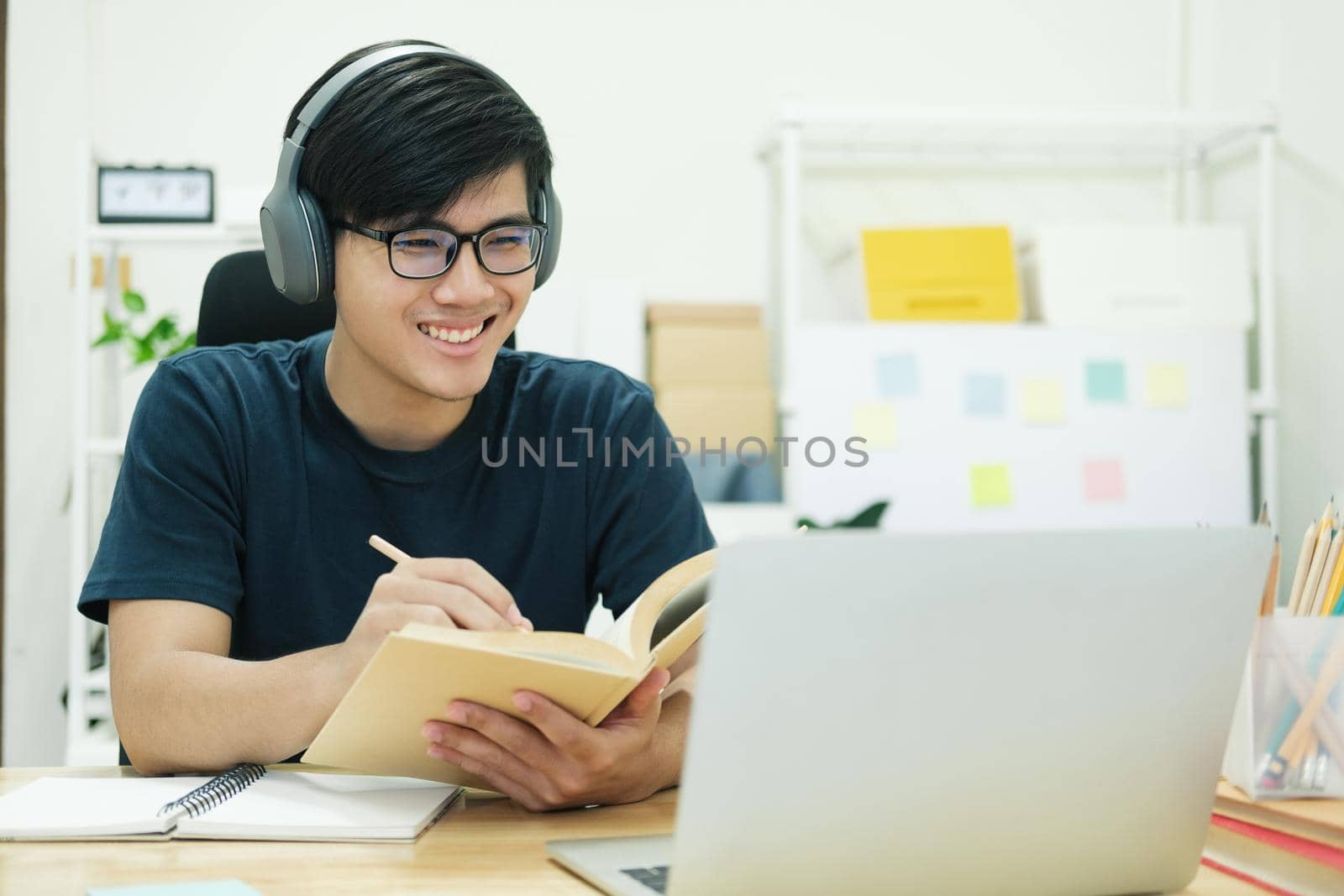 Young male student study at home. He using laptop and learning online.
