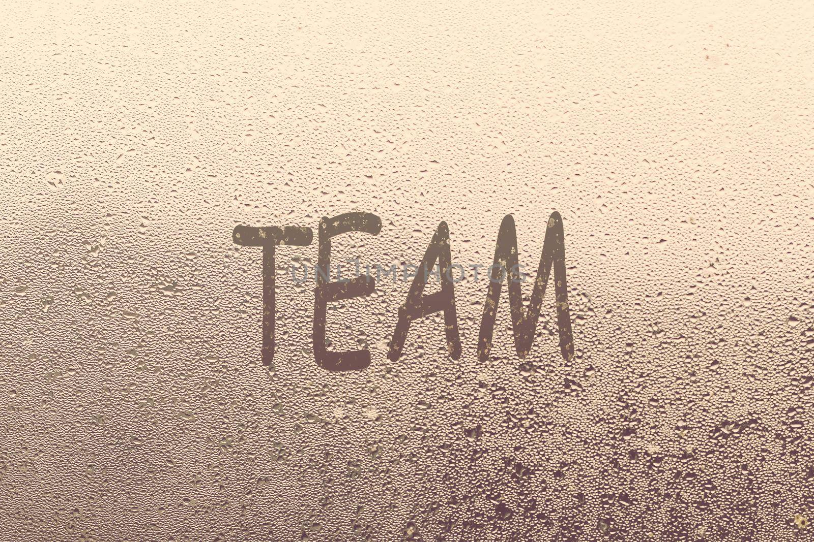 team word written on a window with raindrops by Andelov13