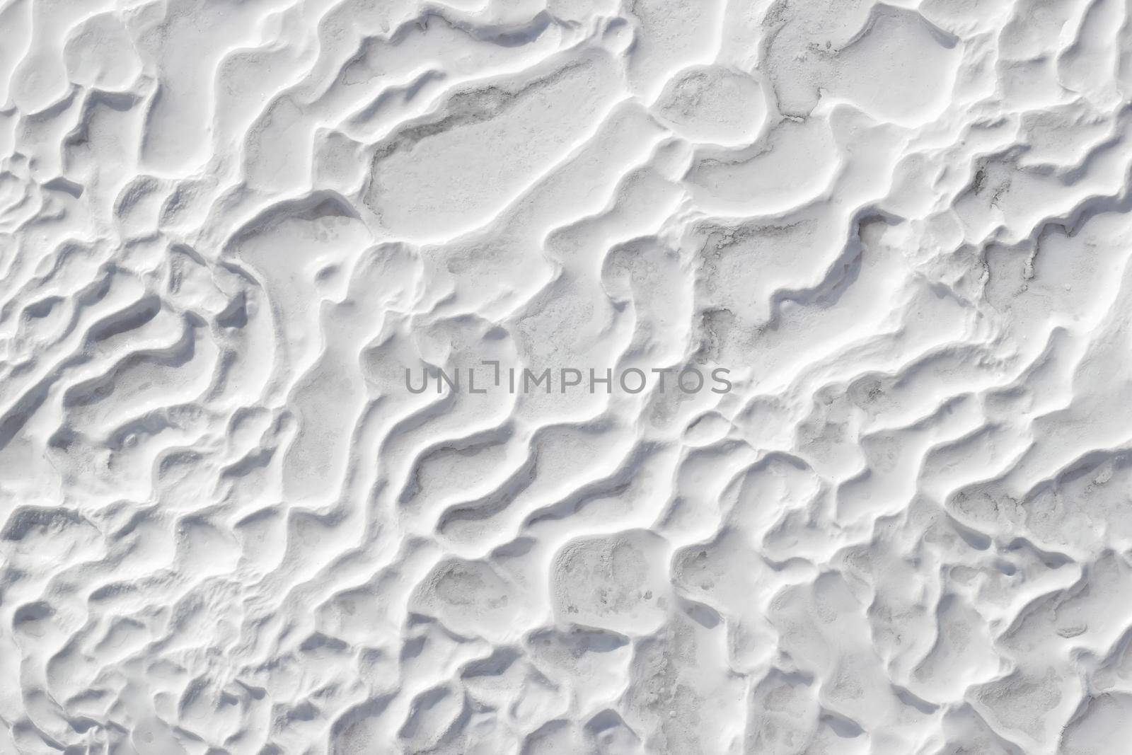 White textured background of Pamukkale calcium travertine in Turkey, abstract pattern by Laguna781