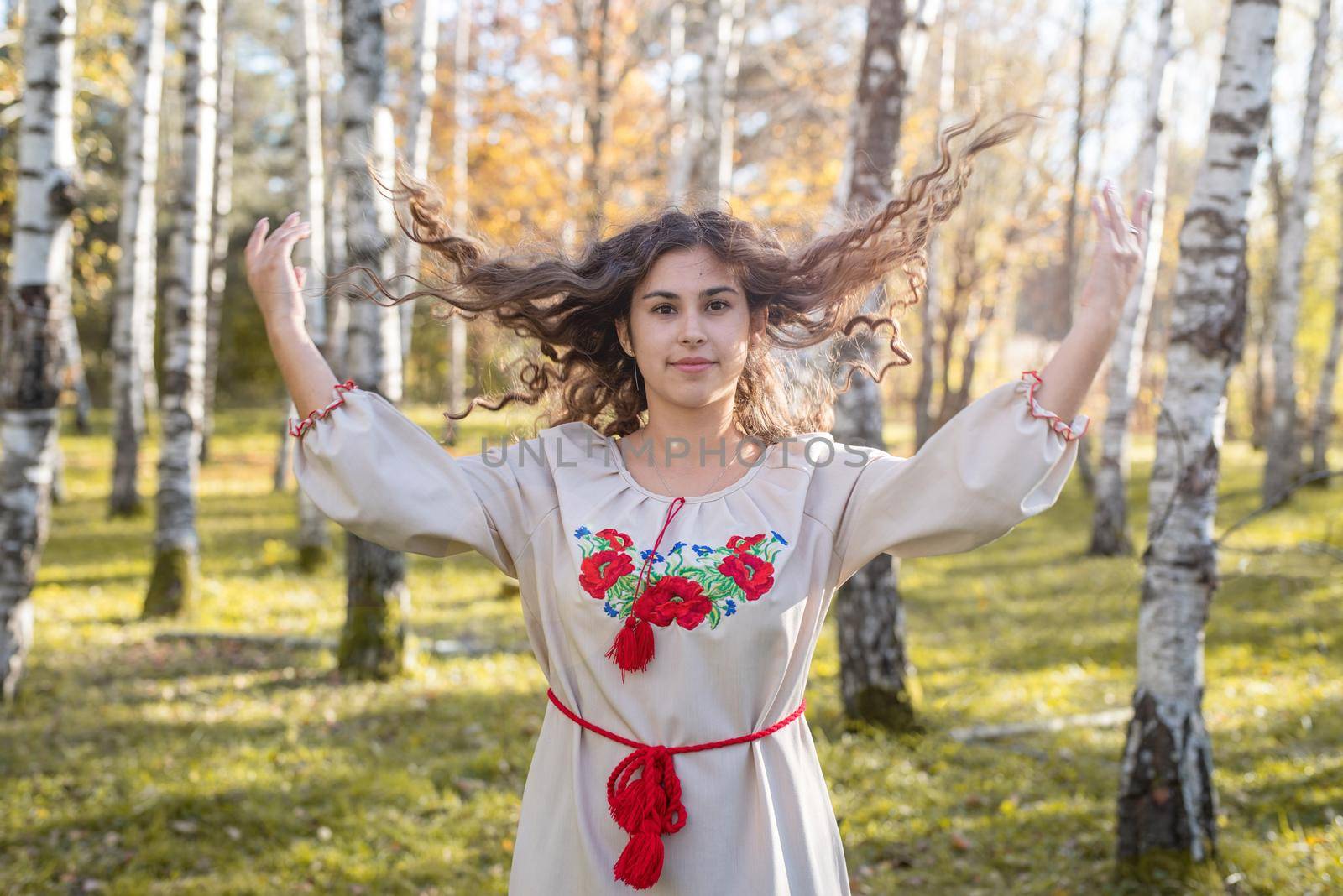 Indigenous people. beautiful woman in national ukrainian national traditional costume clothes walking in forest