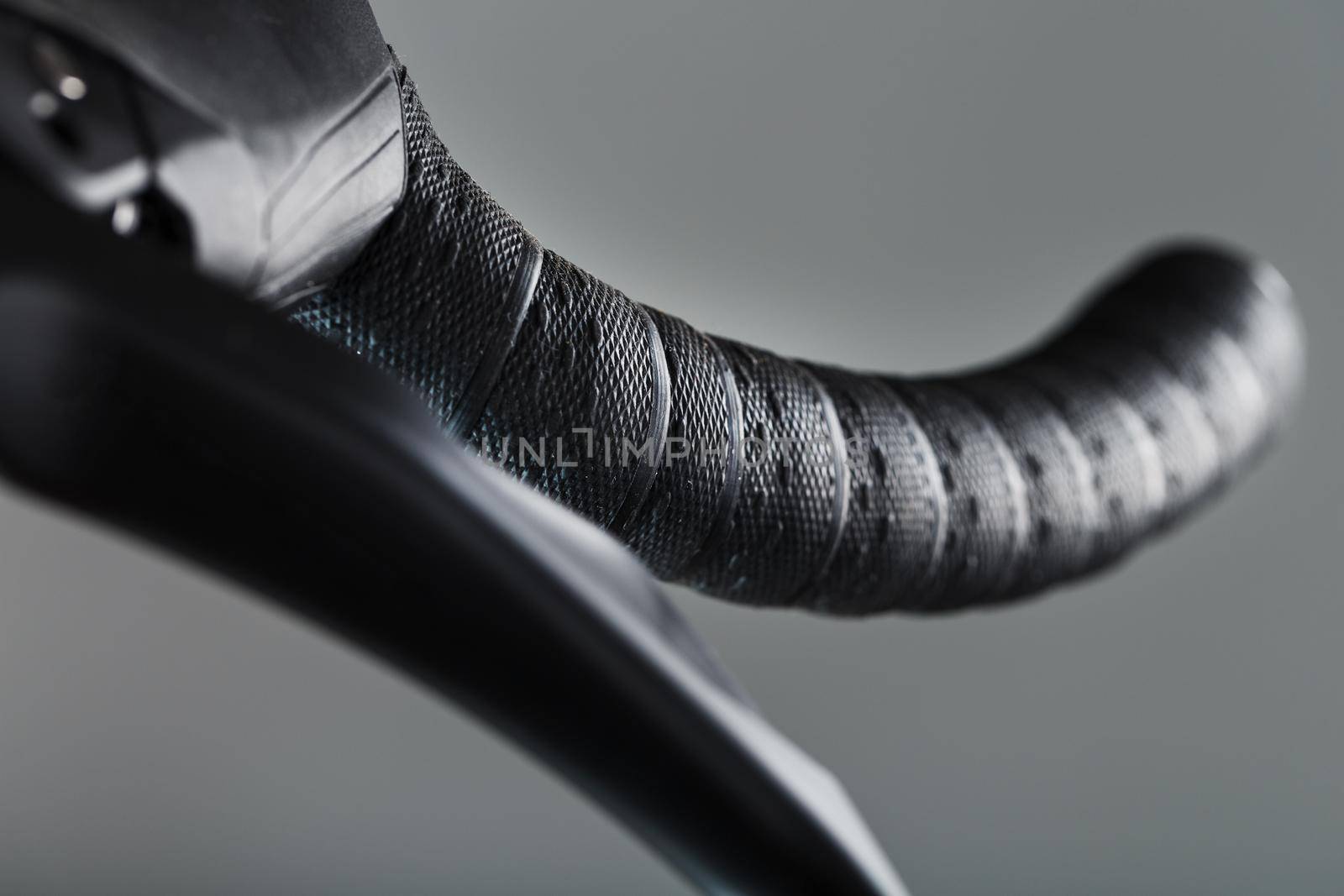 Handlebar winding of a road bike close-up on a gray background