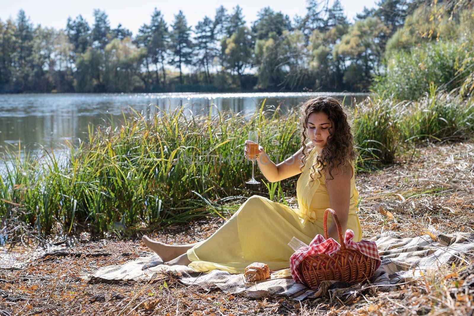 Beautiful woman in yellow dress on a picnic by Desperada