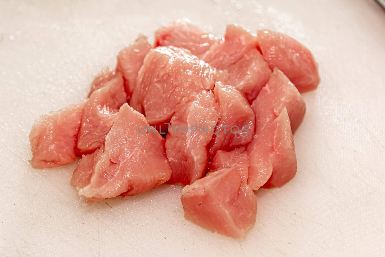 Turkey lean raw fillet and spices on rustic concrete background with knife from above flat lay, healthy diet turkey meat ready to be cooked by Milanchikov