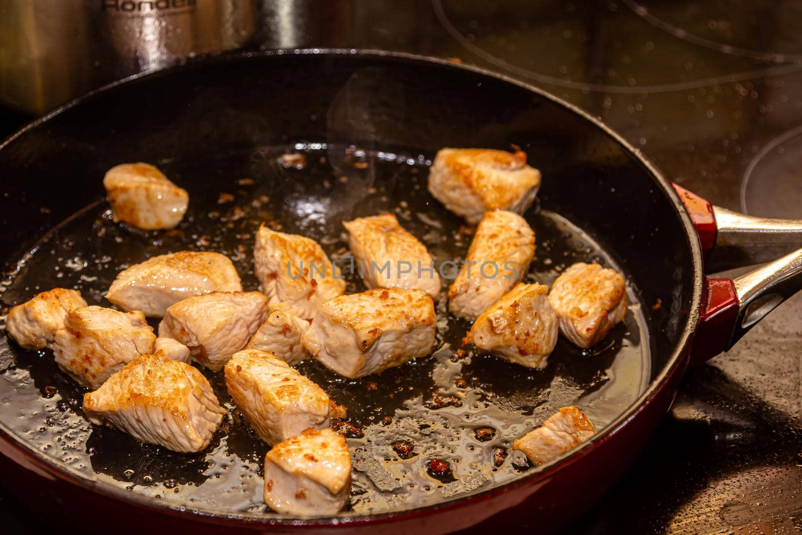 turkey fillet pieces frying on nonstick pan by Milanchikov