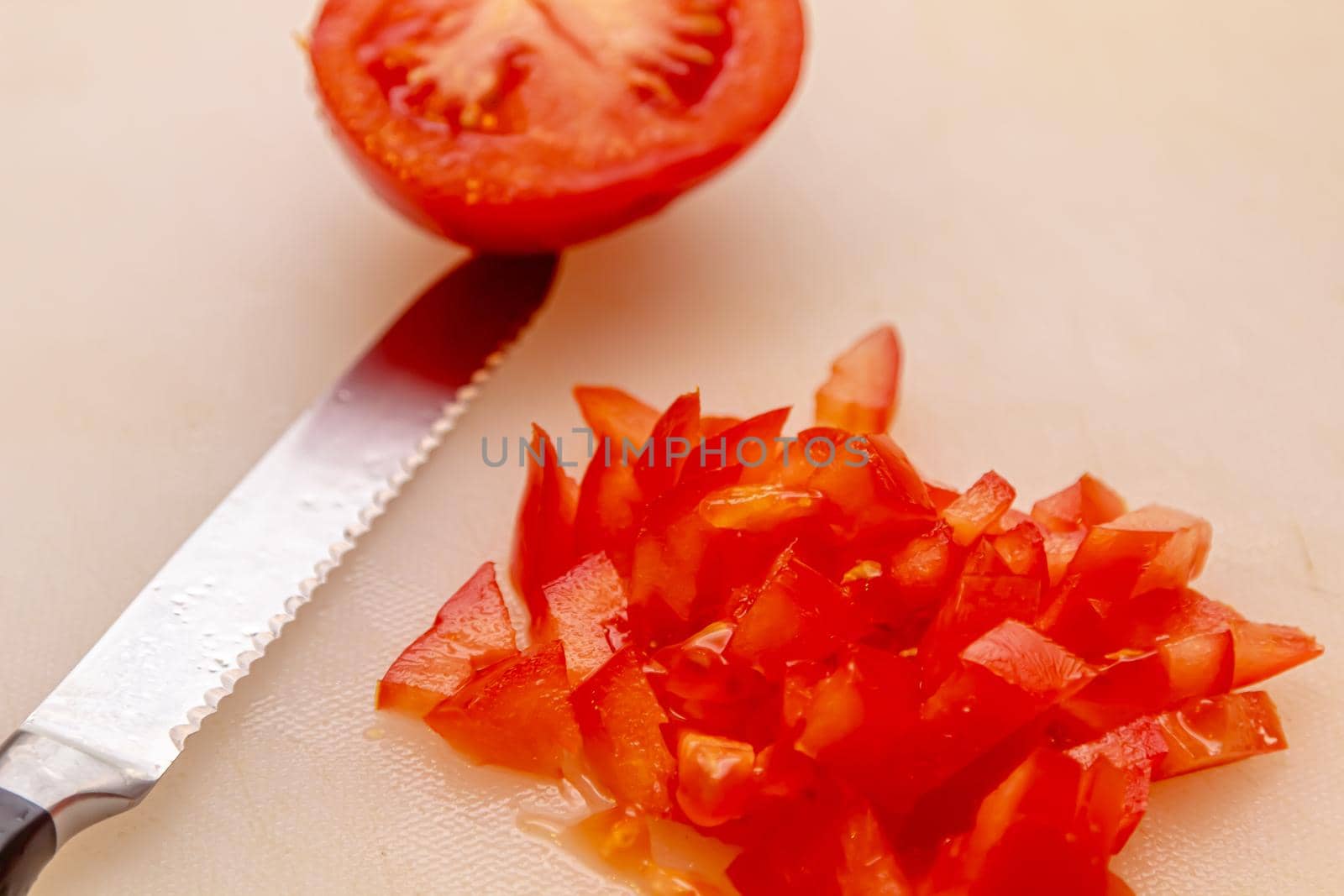 cutting board with a knife and tomato isolated on a white background.