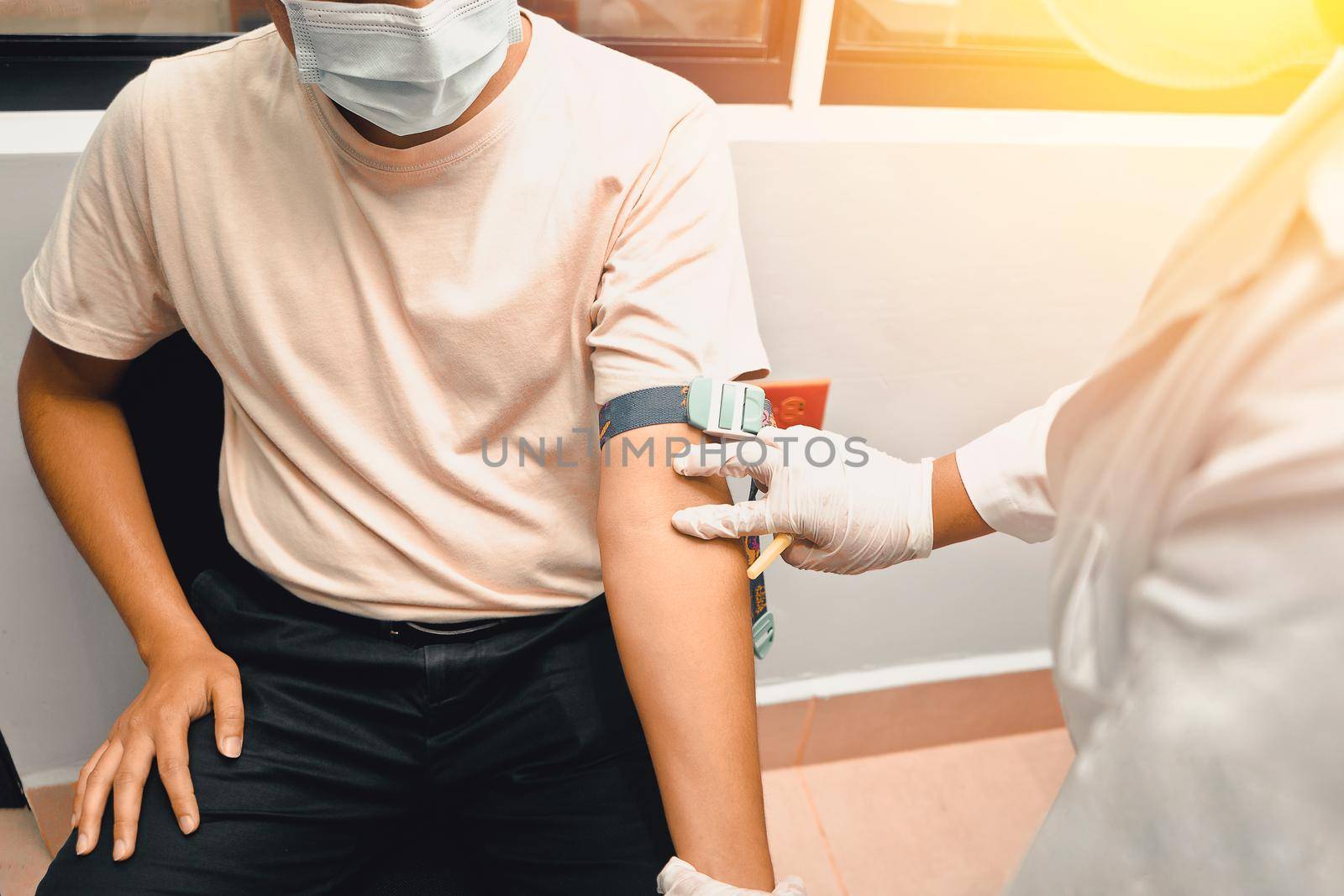 Unrecognizable young Latin man having a blood sample taken in a hospital
