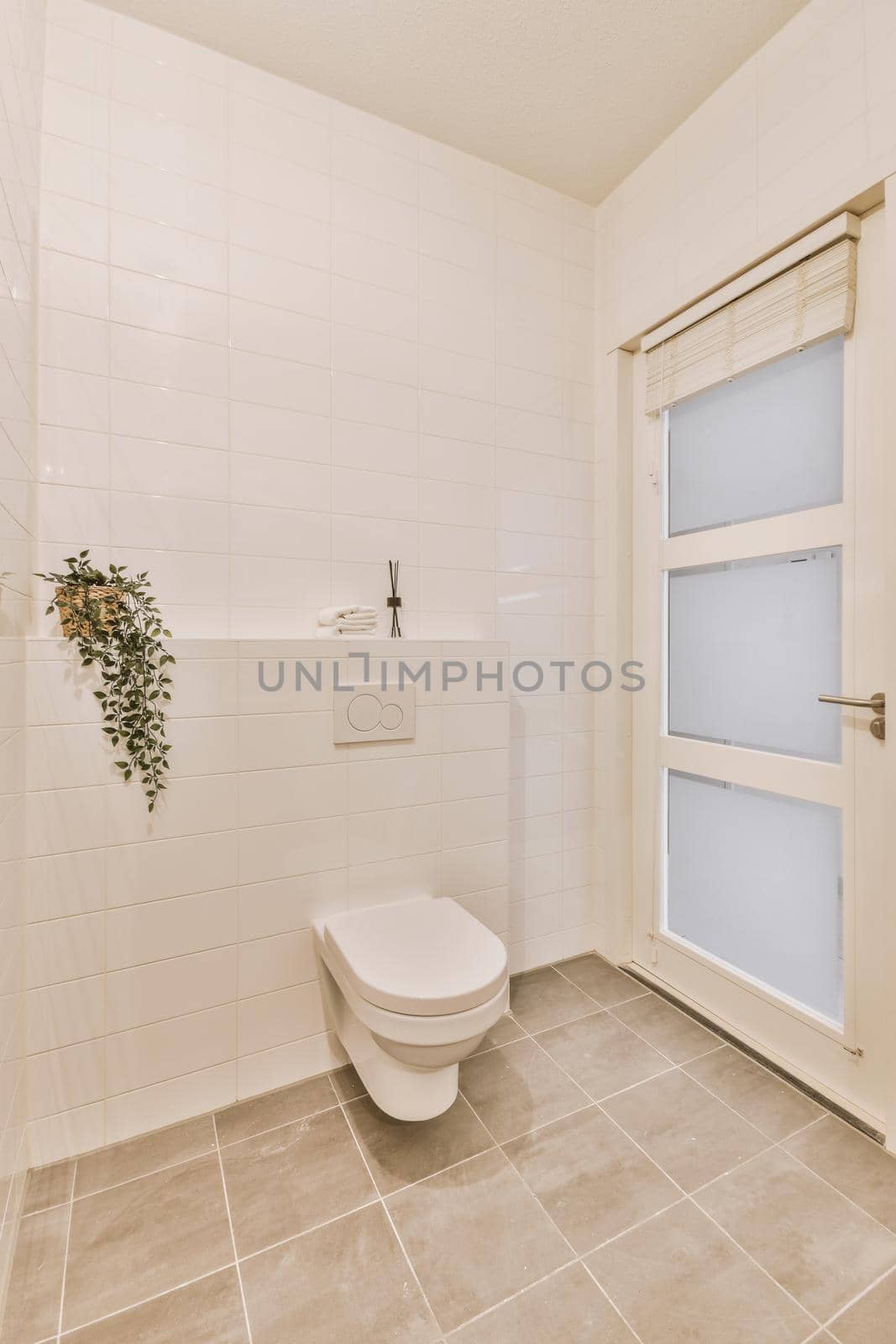 White toilet tub in a bright bathroom with white walls