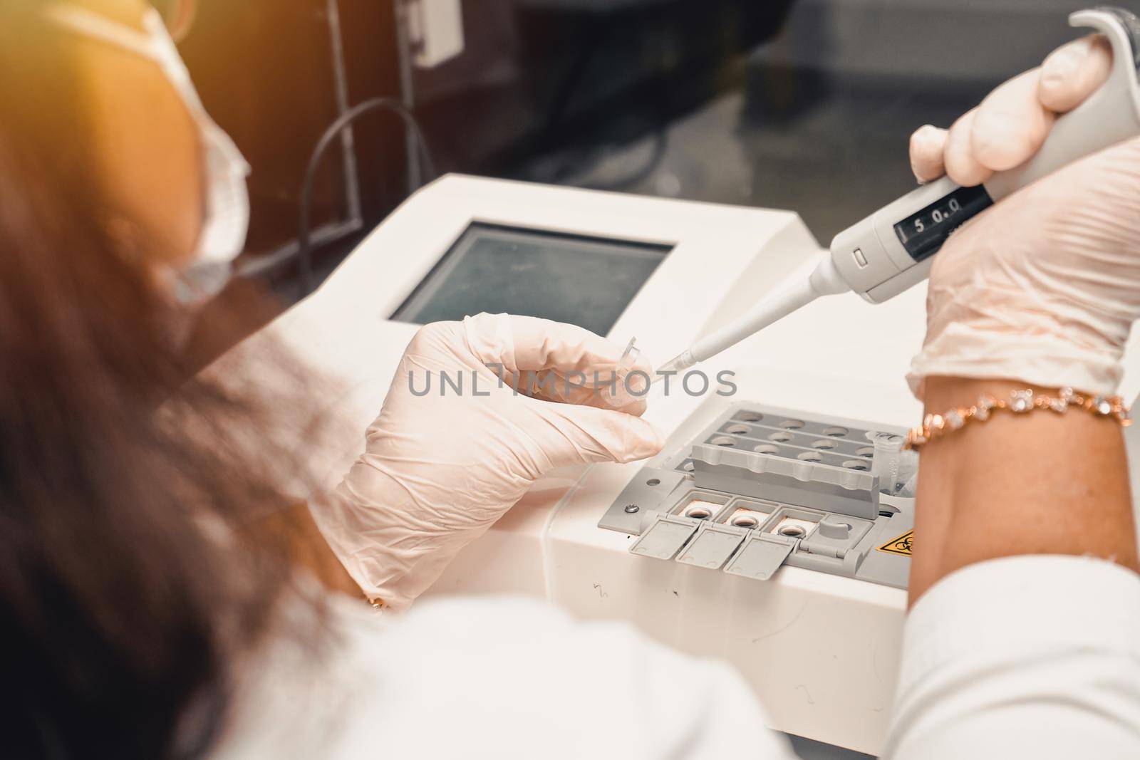 Latin clinical analyst testing medical blood sample in a hospital laboratory
