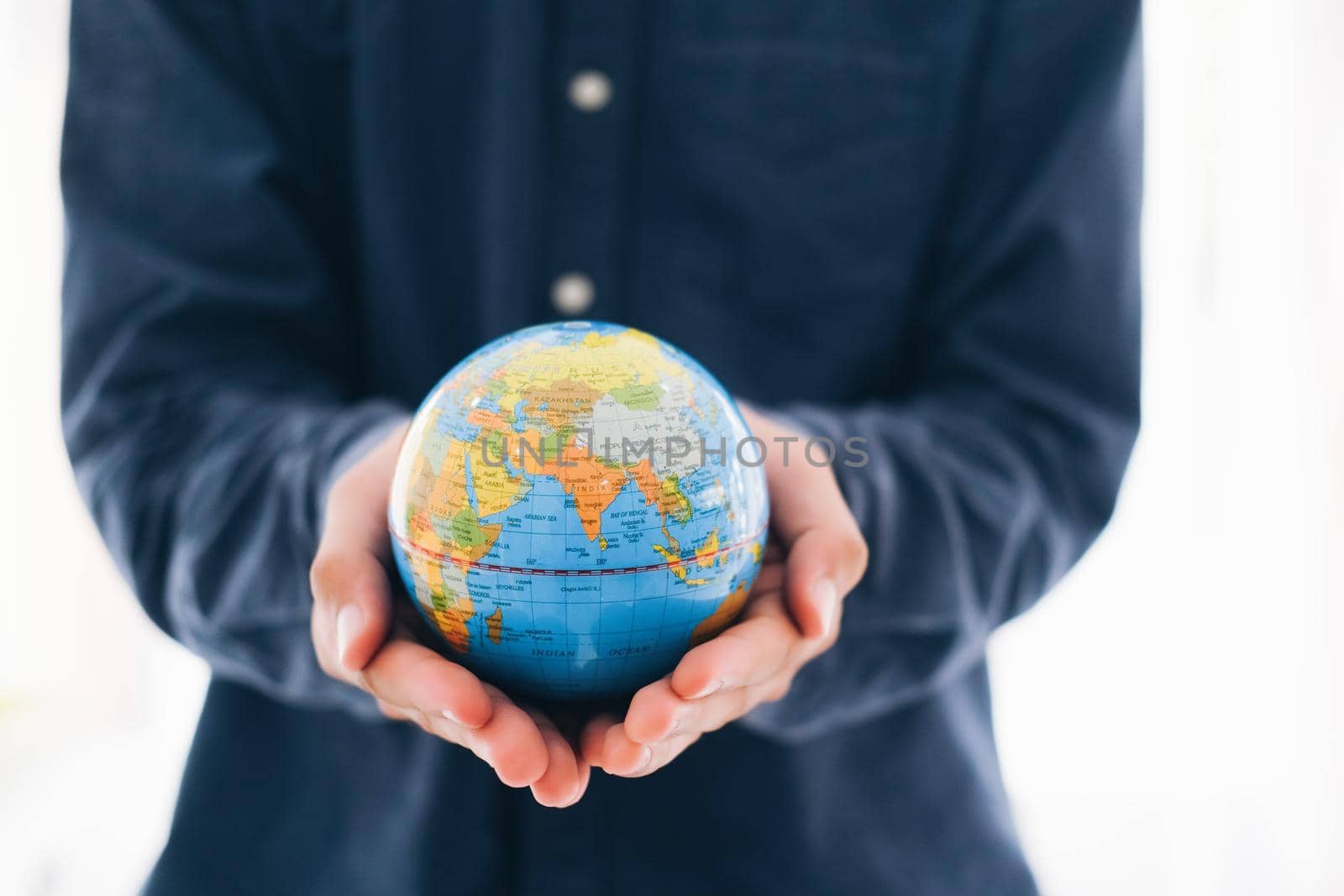 Man holding globe on her hands