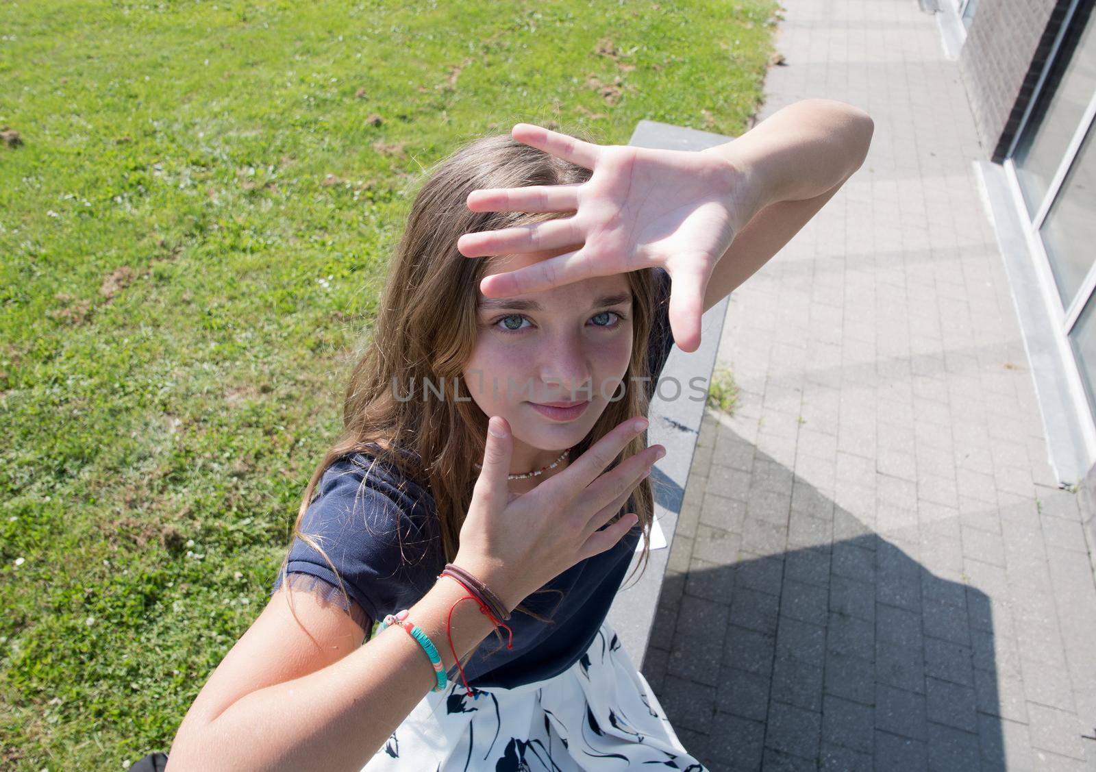 blond teenage girl grimaces and makes faces at camera,children's entertainment by KaterinaDalemans