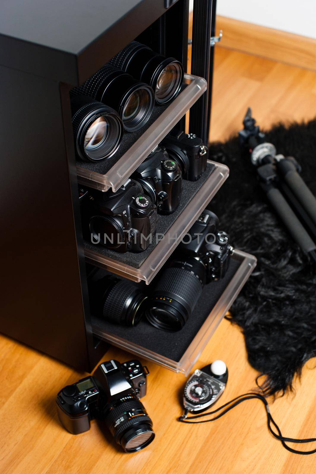 electronic dehumidify dry cabinet for storage cameras lens and other photography equipment. Shallow depth of field, closeup at equipment inside the cabinet.