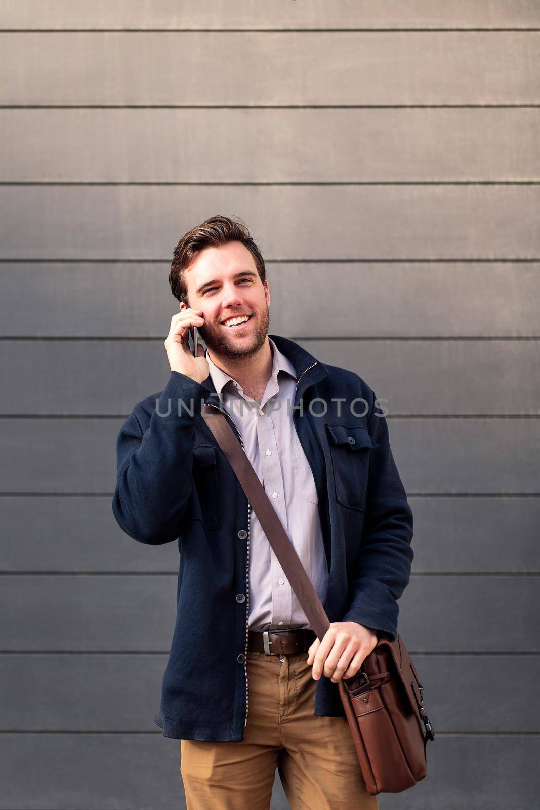 smiling caucasian businessman talking on the phone, concept of entrepreneurship and business, copy space for text