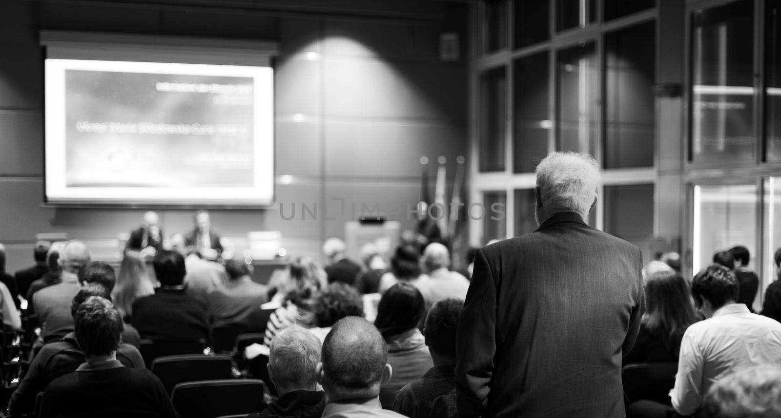 I have a question. Group of business people sitting in conference hall. Businessman raising his arm. Conference and Presentation. Business and Entrepreneurship by kasto
