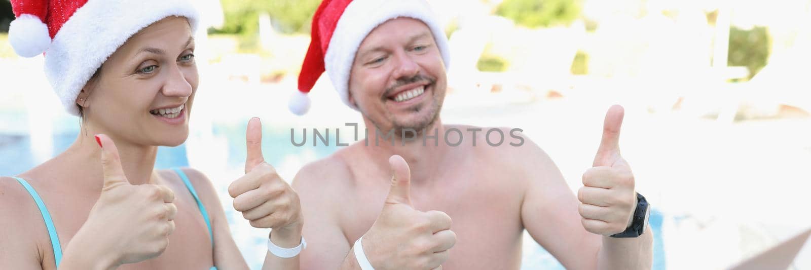 Portrait of happy joyful married spouse show thumbs up to friends. Couple happy about summer holiday, needed relaxation. New year, festive, chill concept