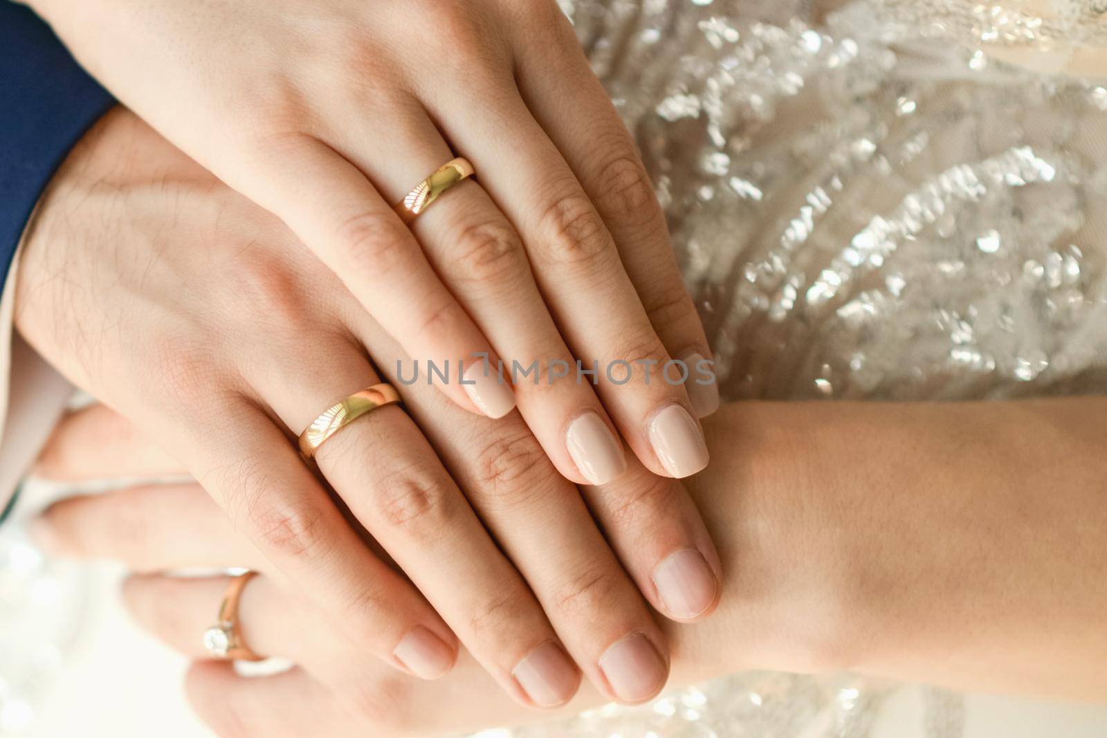 Close up of wedding rings on hands of newlyweds. Hands of the bride and groom