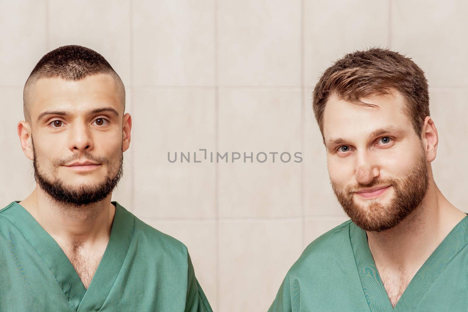 Portrait of two male massage therapists or doctors wearing working clothes at work place.