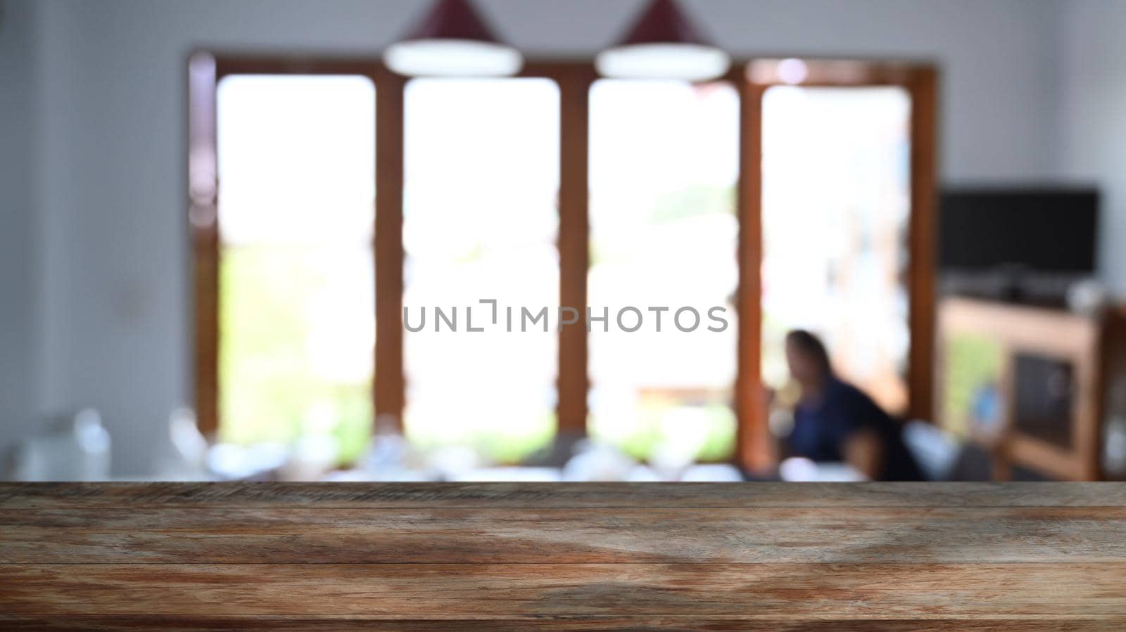 wooden table in front of blurred background of restaurant. Copy pace for display or montage your products. by prathanchorruangsak